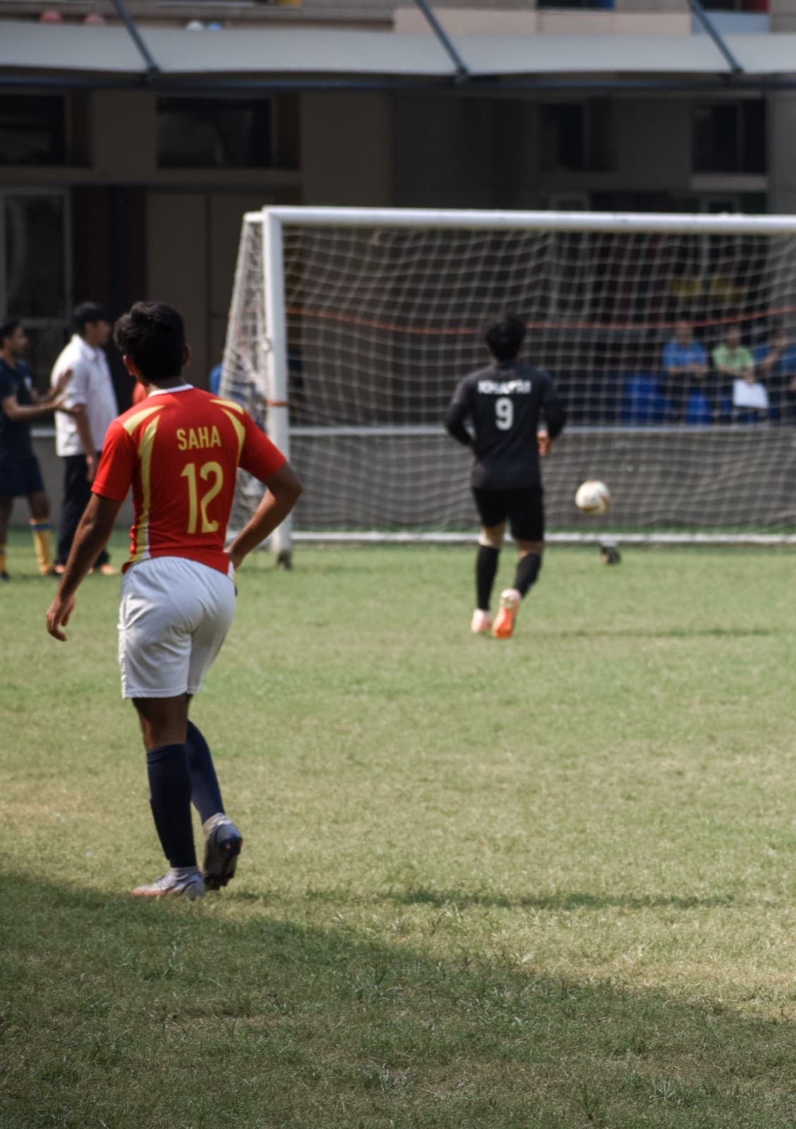 Rohan Saha in a red number 12 jersey during a match
